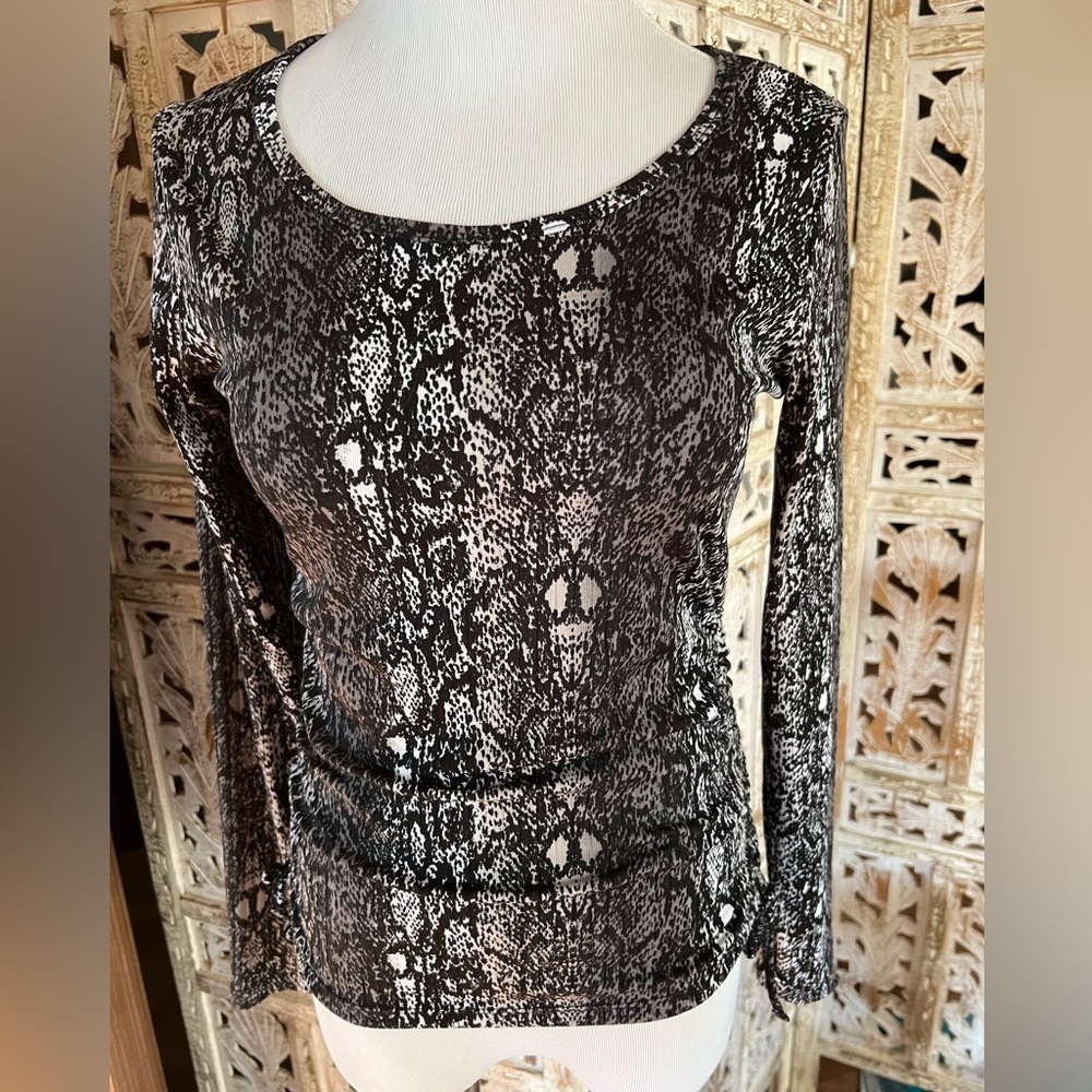 Long sleeve pullover with ties on side. Form fitting